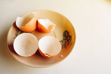 Cracked egg shells on a plateの写真素材
