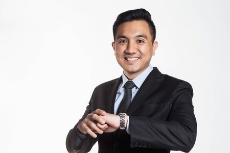 Man in business suit looking at his wrist watchの写真素材