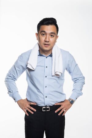Asian man with work attire feeling exhausted and sweatyの写真素材