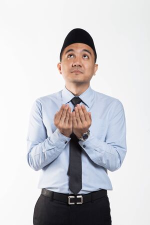 Asian business man in suit and songkok put his hands outの写真素材