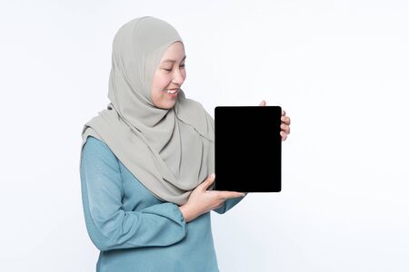 Female muslim woman using a tablet device.の写真素材