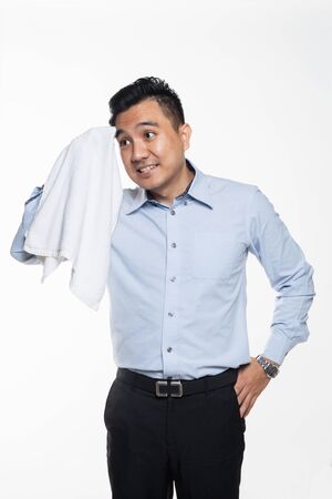 Asian man with work attire feeling exhausted and sweatyの写真素材