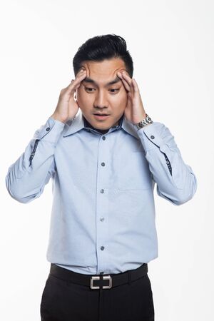 Man having headache at workの写真素材