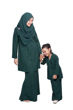 Malay mother and daughter in traditional dress posingの写真素材