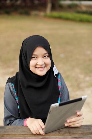 Muslim lady working on smilingの写真素材