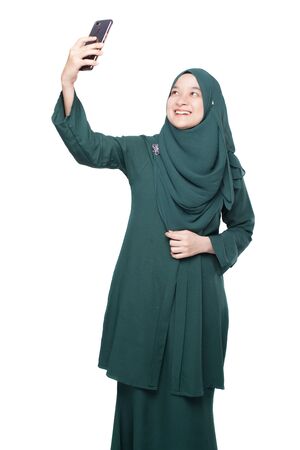 Malay woman taking selfie using smartphoneの写真素材
