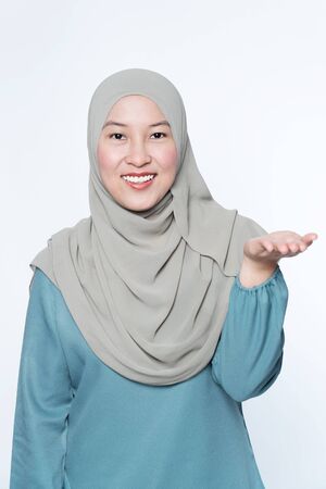 Woman pointing her hands out showing to subject.の写真素材
