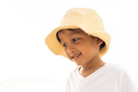 Asian boy smiling while playing at the beach.の写真素材