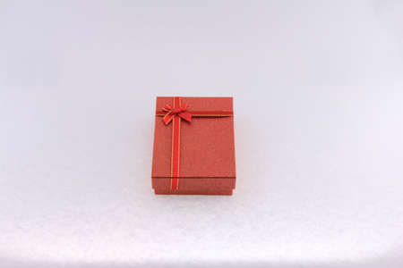 Red gift box with red ribbon on white background. Christmas and New Year concept.の写真素材