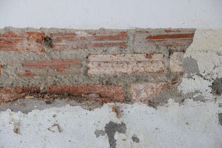 Old brick wall with cracks and scratches. Background and texture for design.の写真素材