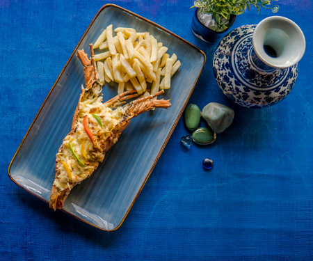 Grilled Lobster served with french fries on blue plate in high qualityの写真素材