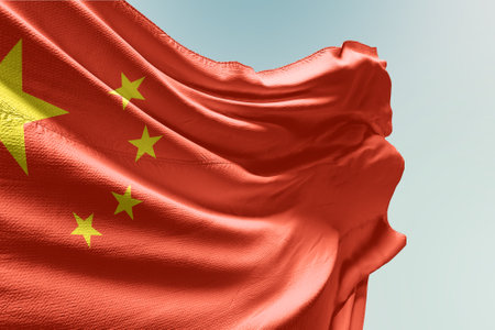 flag of china waving in the wind against blue sky with clouds in high qualityの写真素材