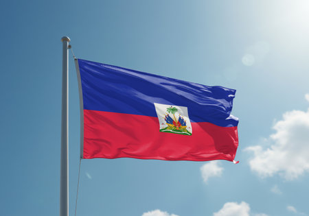 Haiti flag waving in the wind against blue sky with sun raysの写真素材