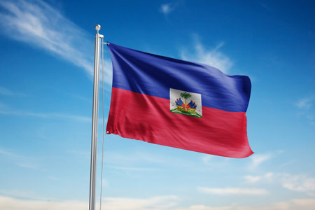 Haiti flag waving in the wind against blue sky with cloudsの写真素材