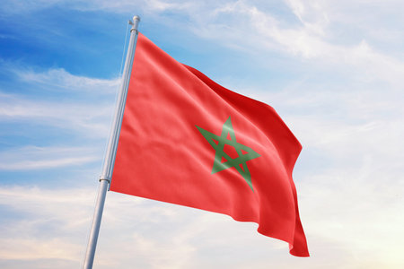 Morocco flag on blue sky background, waving in the windの写真素材