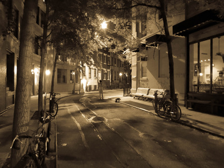 This is photo taken late at night in New York city of a quite neighborhood with a store front settingのeditorial素材