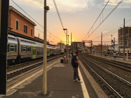 Waiting for a train at the train station in barcelona spain with overhead power linesのeditorial素材
