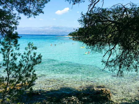 Brac Island Croatia in the middle of summer. With boats and people enjoying summer in the sandy bay.