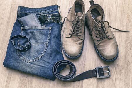 Jeans, belt ,shoes and wallet on wood floorの写真素材