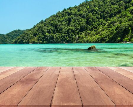 wood table top and blue sky with seascape backgroundの写真素材