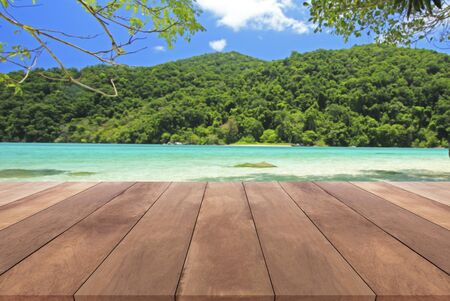 wood table top and blue sky with seascape backgroundの写真素材