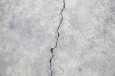 Cracked concrete texture, crack in the wall backgroundの写真素材