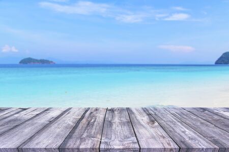 Wood table and beautiful beach with the bright skyの写真素材