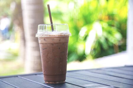 Iced chocolate on wood table with nature blurred backgroundの写真素材