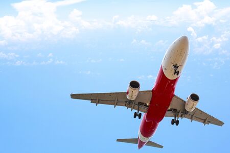 Commercial airplane Flying over cloudy skyの写真素材