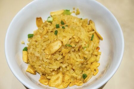Garlic fried rice with vegetable in a bowlの写真素材