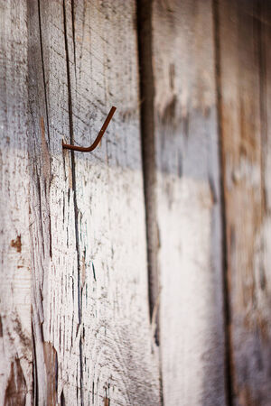 old vintage wooden wall outside near home with rusty nale   の写真素材