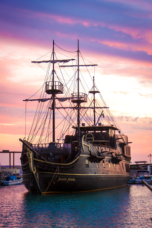 A ship in a harbour against the backdrop of the sunset sky. October, Agia Napa, Cyprusの写真素材