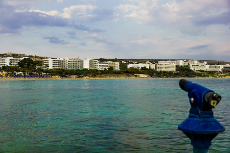 Spyglass at harbour embankment to look at town beach, Agia Napa, Cyprusの写真素材