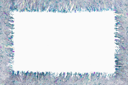 Christmas frame of tinsel garland isolated on whiteの写真素材