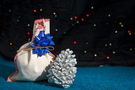Christmas gift and a cone against de-focused lightsの写真素材