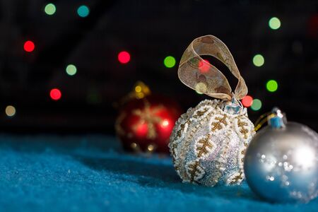 Christmas tree decorations against de-focused lights on blackの写真素材