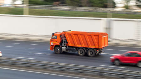 A truck that is driving down the roadの写真素材