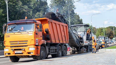 A truck that is driving down the road