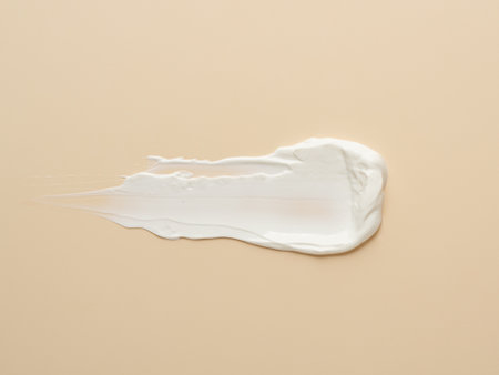 texture of white cream on beige background. stock photography