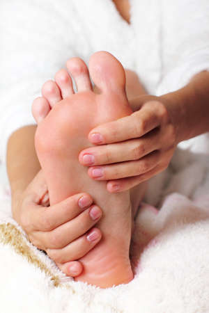 Young woman massaging his feetの写真素材