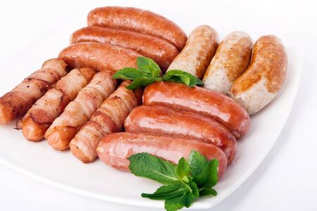 Grilled sausages on white plateの写真素材