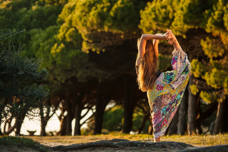 Girl is doing yoga in the forestの写真素材