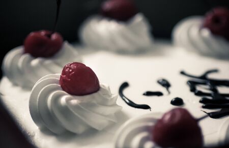 Red cherry on top of white cakeの写真素材