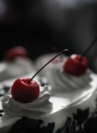 long stem Cherry on top of a cakeの写真素材