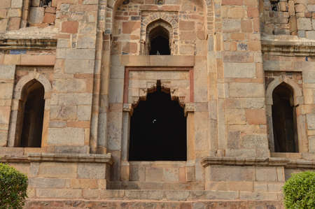 A design at gate of shish gumbad monument at lodi garden or lodhi gardens in a city park from the side of the lawn at winter foggy morning.の写真素材