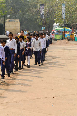 A bunch of children going to visit national zoological park standing in queue outside of Delhi Zoo.