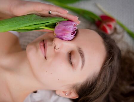 Portrait of a girl with tulips. Portrait of a girl without makeupの写真素材