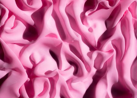 Wave texture. The texture of the pink fabric. Background for the site. Pale pink color background