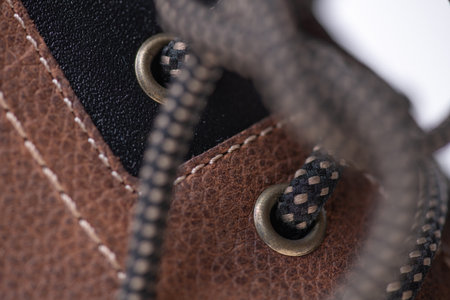 Fragment of fashionable men's brown winter boot made of genuine leather with fur.