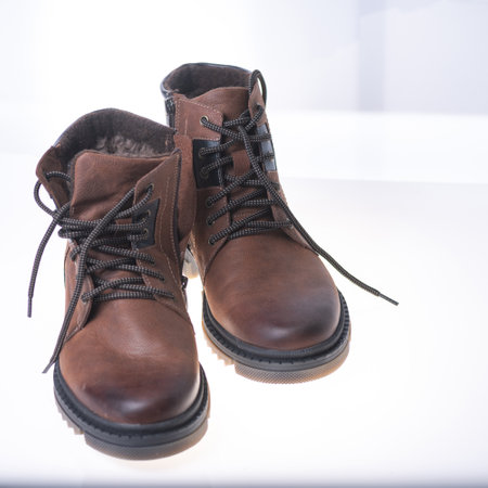 Men's winter boot made of genuine leather and natural fur on a light background.の写真素材